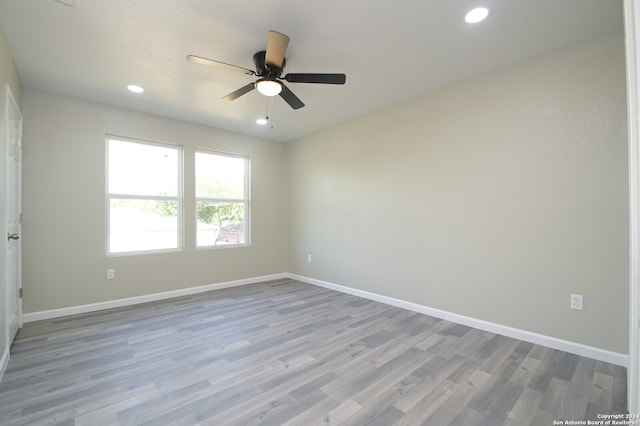 spare room featuring light wood-type flooring and ceiling fan