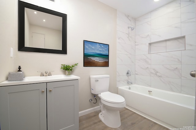 full bathroom featuring tiled shower / bath combo, vanity, toilet, and hardwood / wood-style flooring