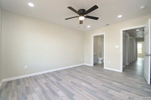 unfurnished bedroom featuring light hardwood / wood-style flooring, connected bathroom, and ceiling fan