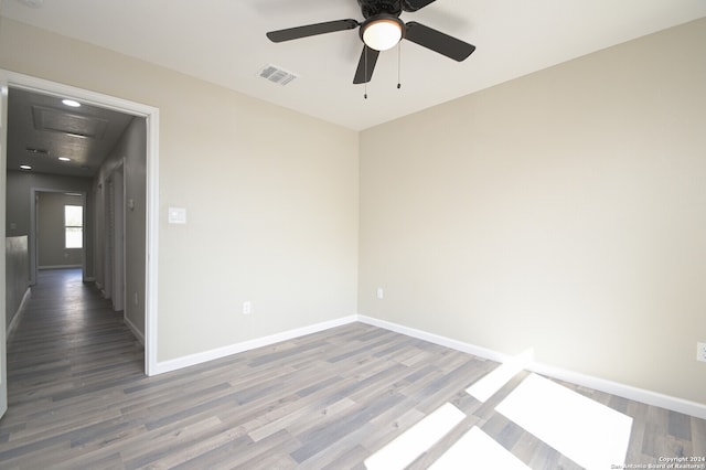 empty room with hardwood / wood-style floors and ceiling fan