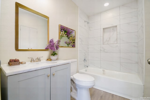 full bathroom with wood-type flooring, vanity, toilet, and tiled shower / bath