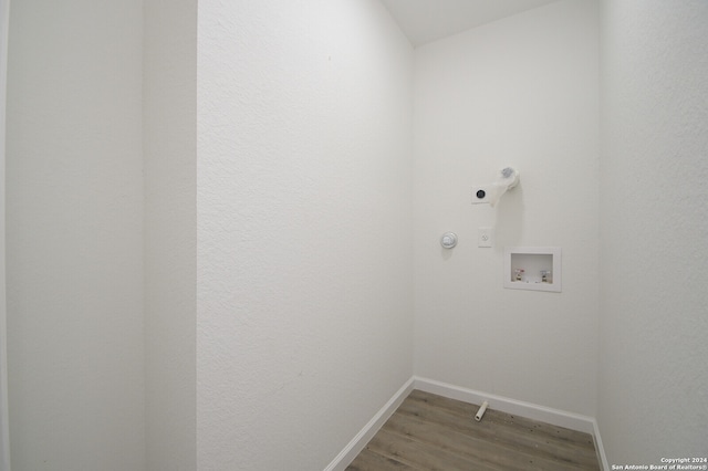 clothes washing area featuring wood-type flooring, electric dryer hookup, and hookup for a washing machine