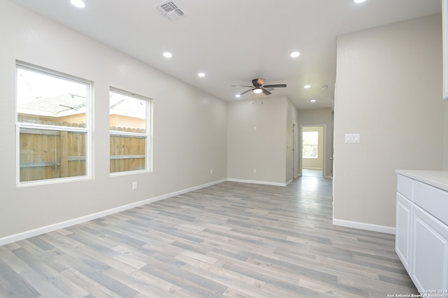 unfurnished room with ceiling fan and light wood-type flooring