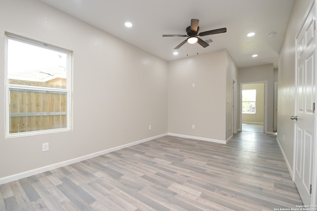 unfurnished room with ceiling fan and light wood-type flooring