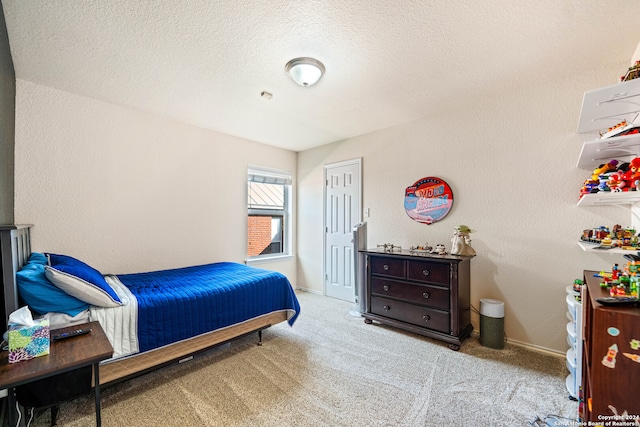 carpeted bedroom featuring a textured ceiling