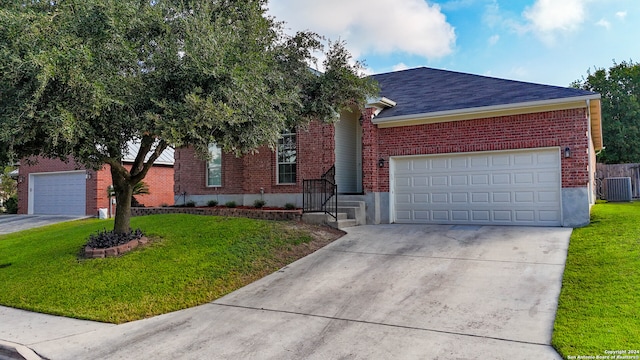 ranch-style home featuring a garage, a front lawn, and central AC unit