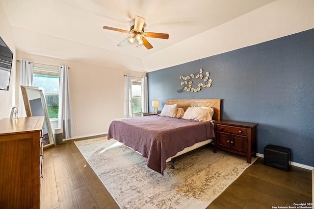 bedroom with ceiling fan and dark wood-type flooring