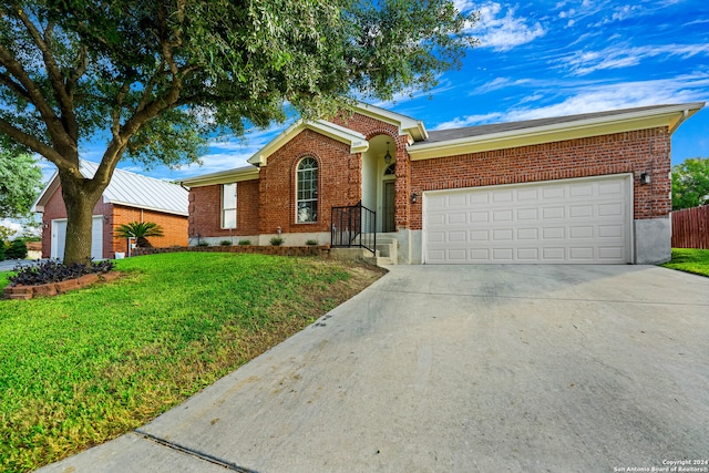 single story home featuring a front lawn and a garage