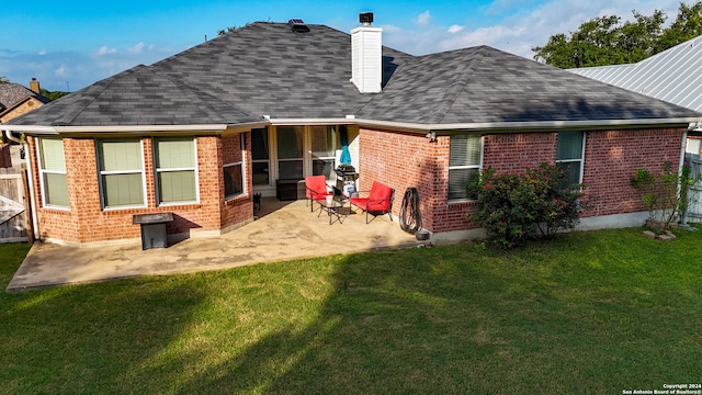 back of property featuring a yard and a patio