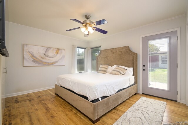 bedroom featuring ceiling fan, crown molding, and hardwood / wood-style floors