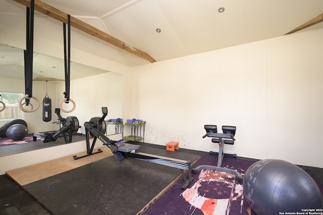 exercise room with vaulted ceiling