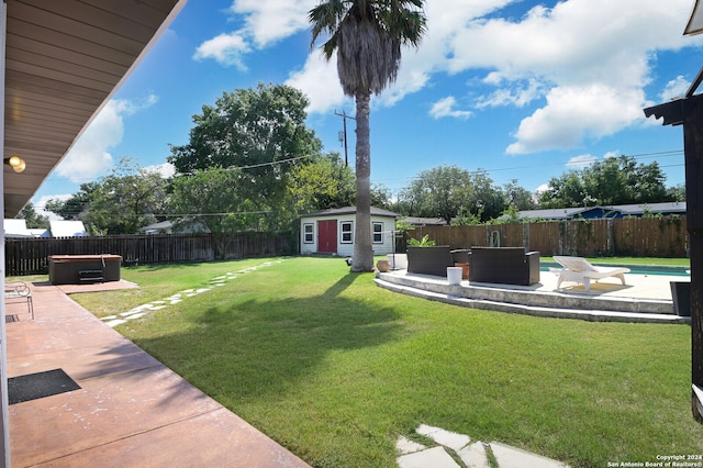 view of yard featuring a fenced in pool, a patio, and a shed