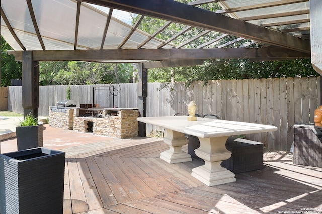 wooden deck with area for grilling and a pergola