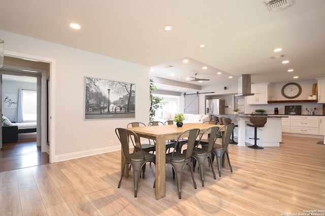 dining space with light hardwood / wood-style floors, ceiling fan, and a wealth of natural light