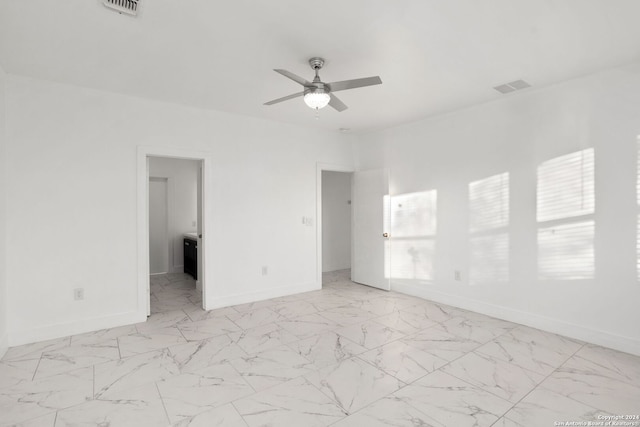 unfurnished room featuring ceiling fan and a wealth of natural light