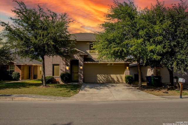 view of front of home featuring a lawn and a garage