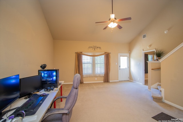 carpeted home office with ceiling fan and high vaulted ceiling