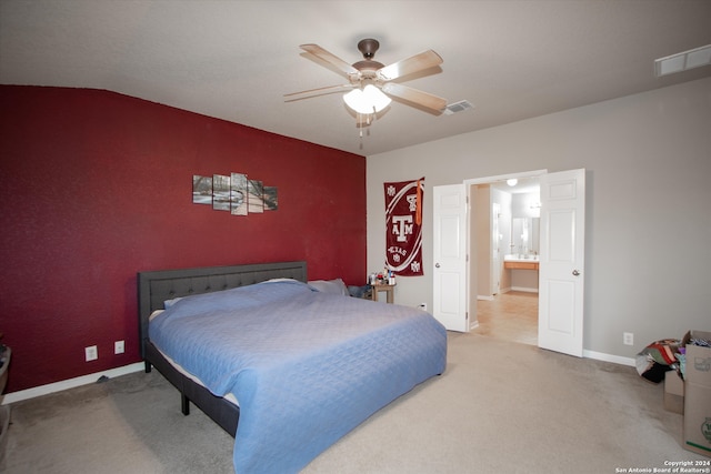 carpeted bedroom featuring ceiling fan, connected bathroom, and vaulted ceiling