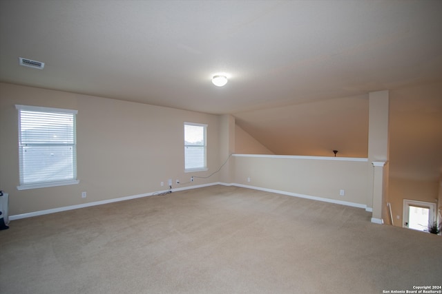 additional living space with light carpet and lofted ceiling