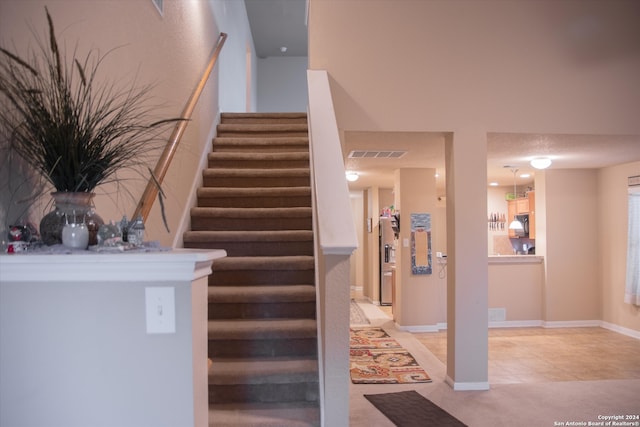 staircase with tile patterned floors