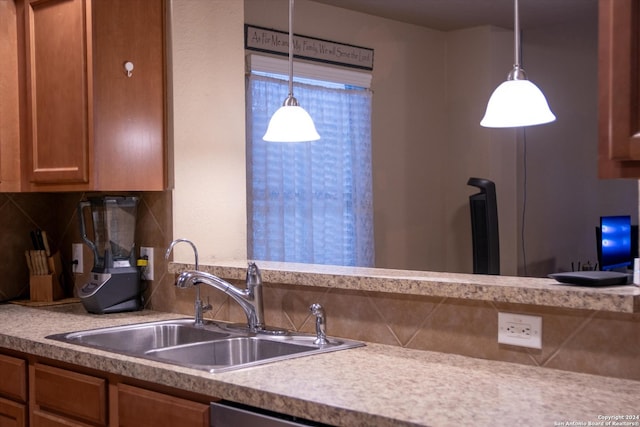 9171 Everton, San Antonio, TX 78245 - kitchen with a sink, pendant lighting, backsplash, and brown cabinets