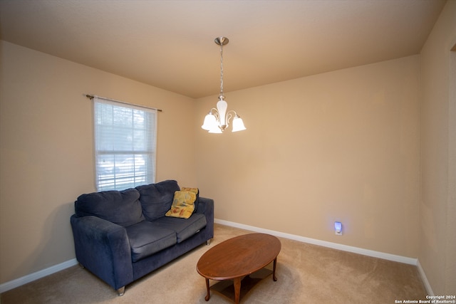 living area with carpet flooring and a notable chandelier