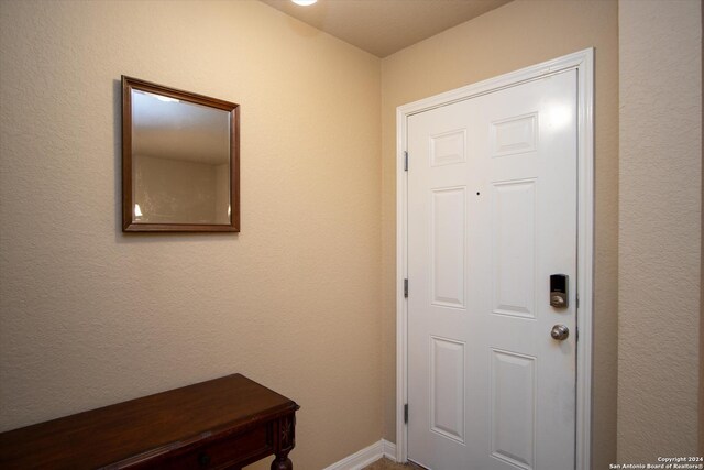 9171 Everton, San Antonio, TX 78245 - doorway to outside featuring baseboards