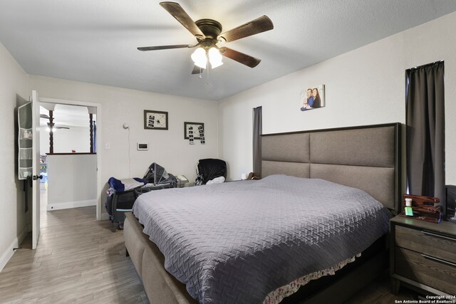 bedroom with wood-type flooring and ceiling fan