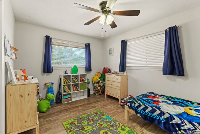 bedroom with wood-type flooring and ceiling fan