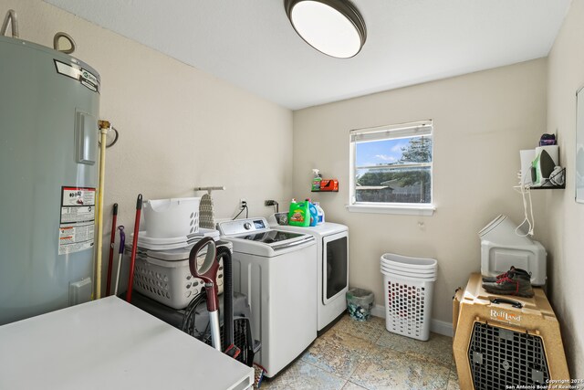 laundry area featuring washing machine and clothes dryer and electric water heater