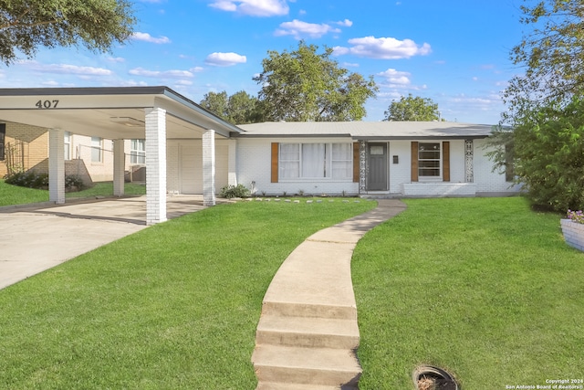 view of front facade with a carport and a front lawn