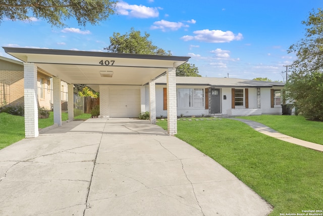 view of front of house featuring a front lawn, a carport, and a garage