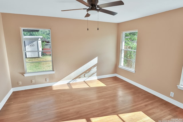 empty room with light hardwood / wood-style flooring, ceiling fan, and a healthy amount of sunlight