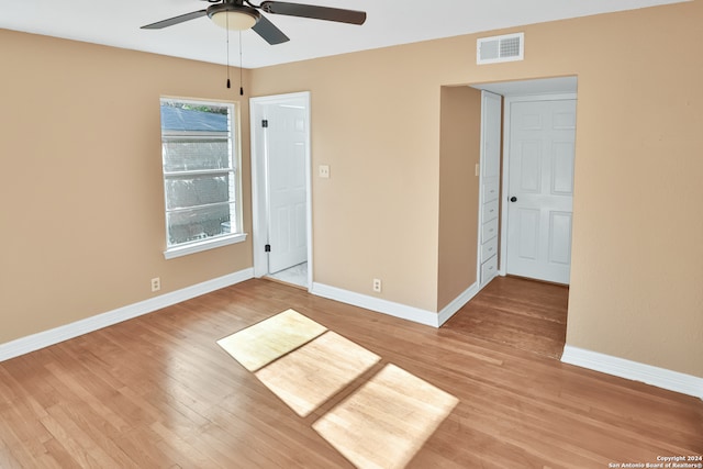 empty room with ceiling fan and hardwood / wood-style flooring