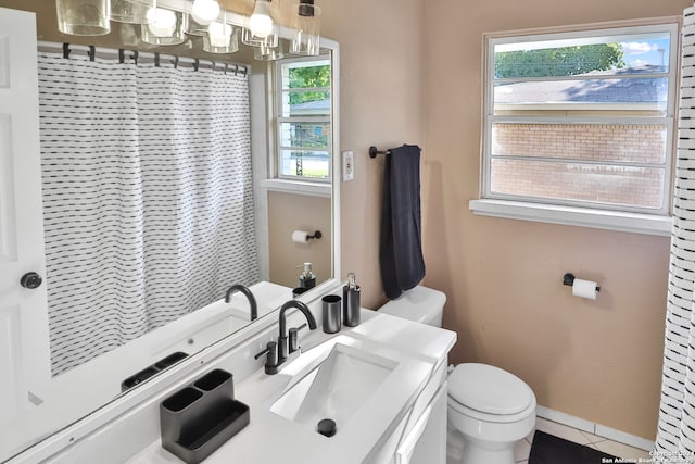 bathroom with vanity, tile patterned flooring, and toilet