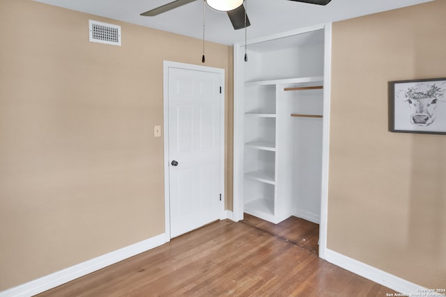 unfurnished bedroom featuring a closet, ceiling fan, and hardwood / wood-style floors