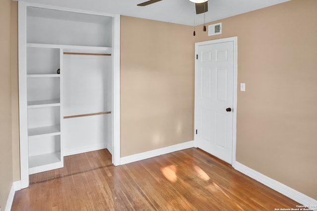 unfurnished bedroom with a closet, ceiling fan, and hardwood / wood-style floors