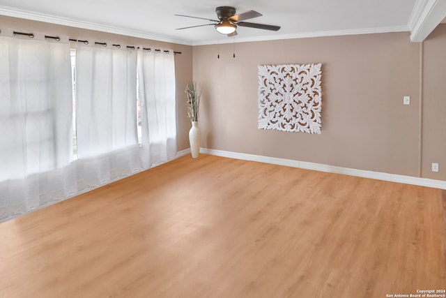 empty room with ornamental molding, hardwood / wood-style floors, and ceiling fan