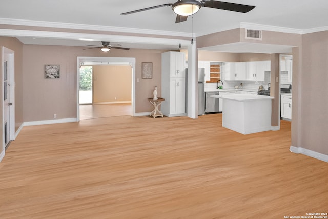 kitchen with crown molding, white cabinetry, ceiling fan, and light hardwood / wood-style flooring