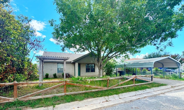 view of front of home with a front yard and a carport