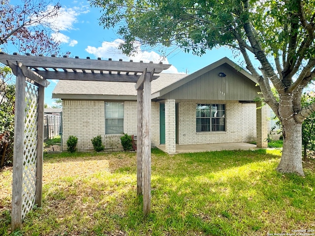 ranch-style home featuring a patio, a pergola, and a front yard