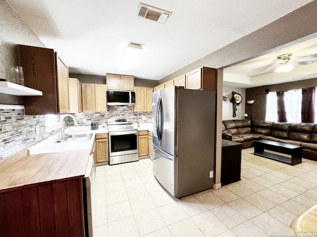 kitchen with ceiling fan, light tile patterned floors, sink, tasteful backsplash, and appliances with stainless steel finishes