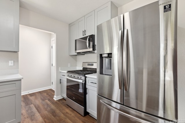 kitchen featuring stainless steel appliances, white cabinets, and dark hardwood / wood-style floors