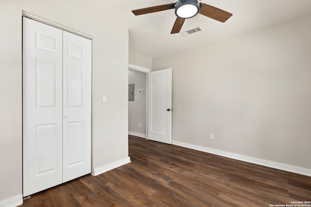 unfurnished bedroom featuring ceiling fan, a closet, and dark hardwood / wood-style flooring