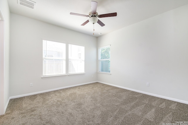 unfurnished room featuring ceiling fan and carpet