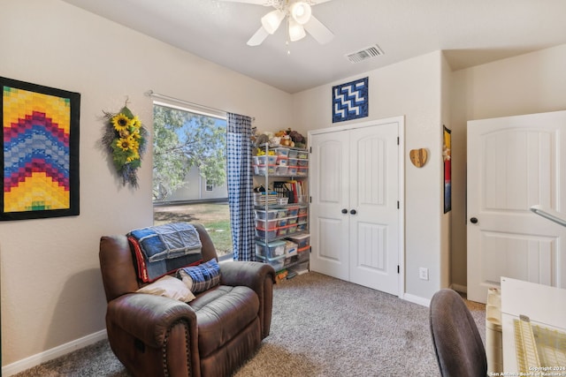 sitting room featuring ceiling fan and carpet floors