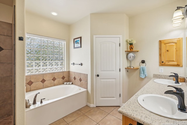 bathroom featuring vanity, a bath, and tile patterned floors