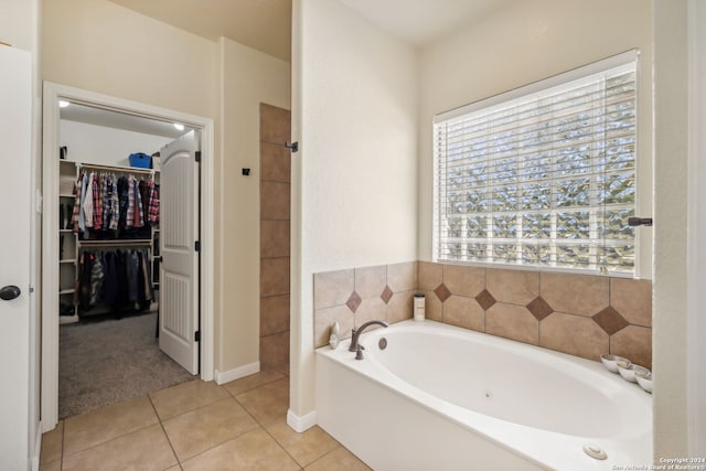 bathroom with tile patterned flooring and a washtub