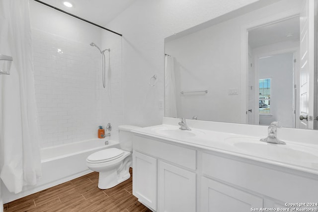 full bathroom with vanity, toilet, hardwood / wood-style floors, and shower / bathtub combination with curtain