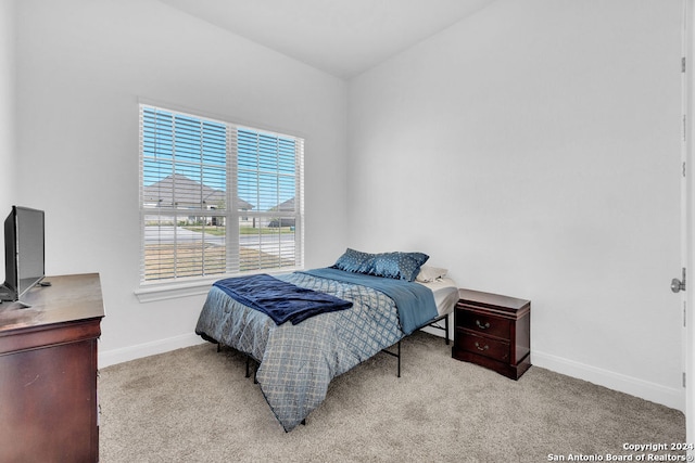 carpeted bedroom with vaulted ceiling